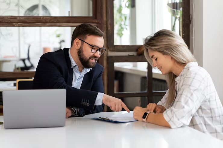 A female entrepreneur consulting with a professional before purchasing a commercial property and securing commercial real estate financing